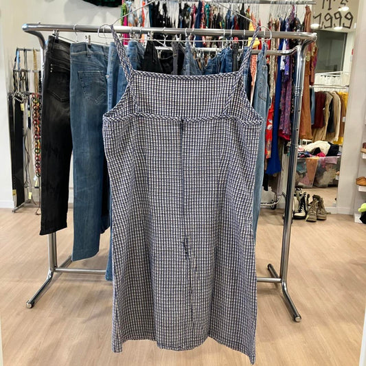 Plaid dress hanging on a rack in a store setting