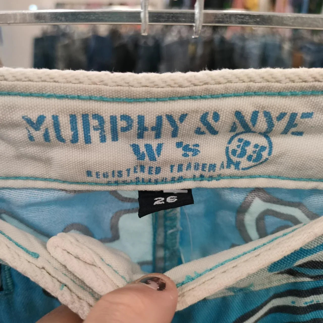 Close-up of Murphy & Nye blue patterned jeans waistband with size 26 tag, second hand denim.