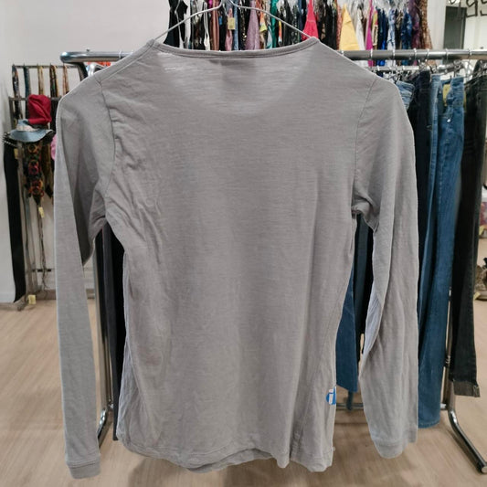 Grey long sleeve shirt on hanger in second hand fashion store