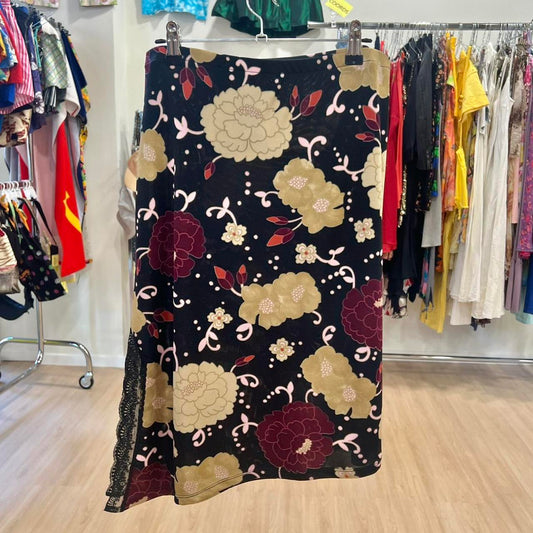 Floral-patterned dress hanging on a rack in a clothing store