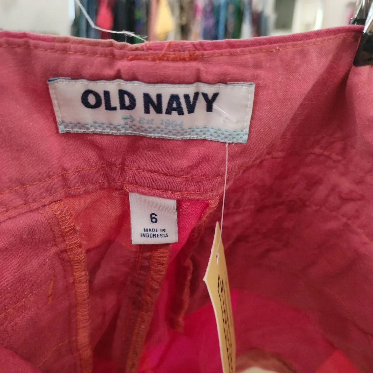Closeup of pink Old Navy pants waistband with size 6 tag, sustainable secondhand fashion