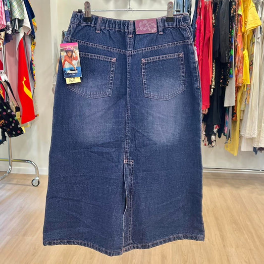 Blue denim skirt on a hanger with a clothing rack in the background
