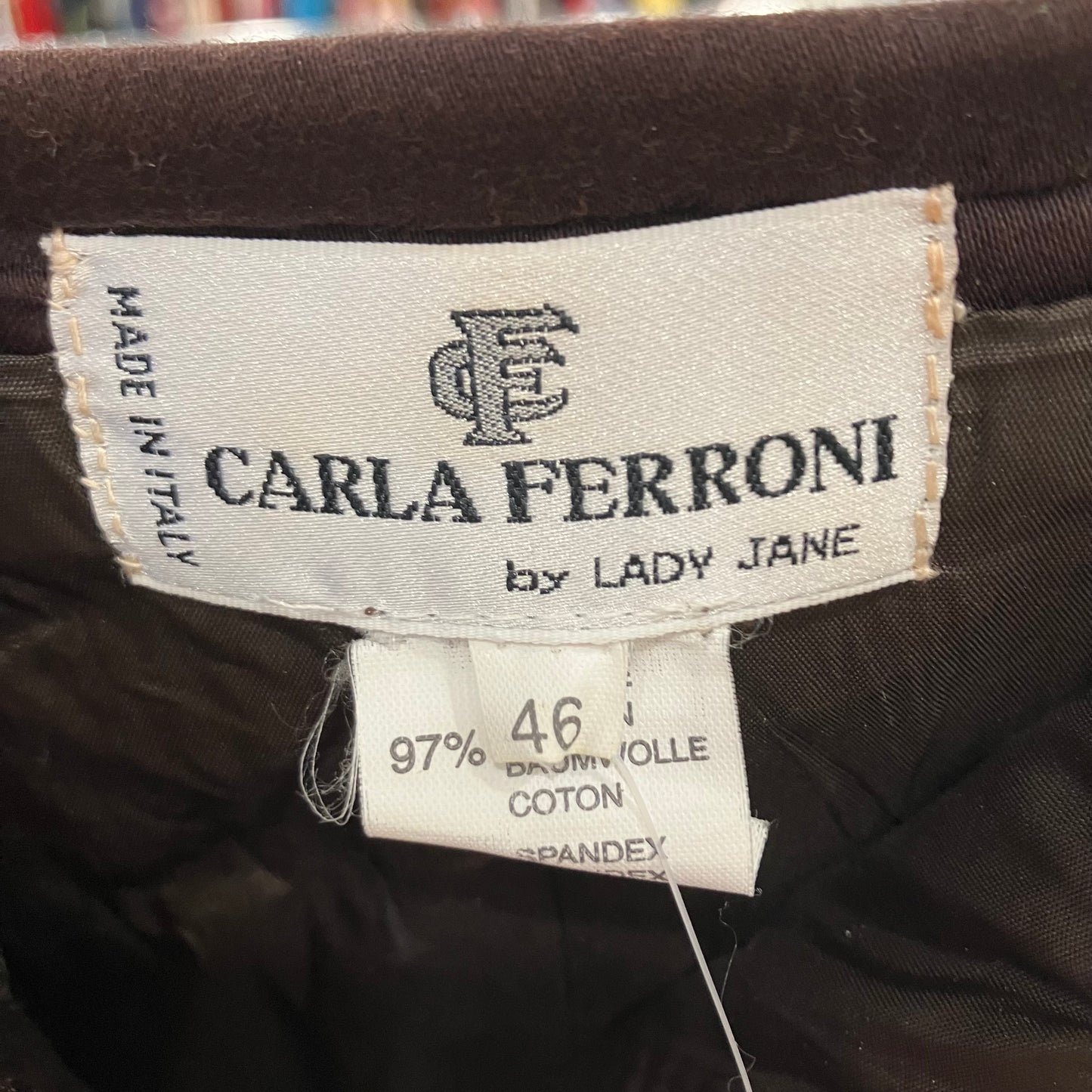 Label with 'CARLA FERRONI by LADY JANE' on a dark fabric background