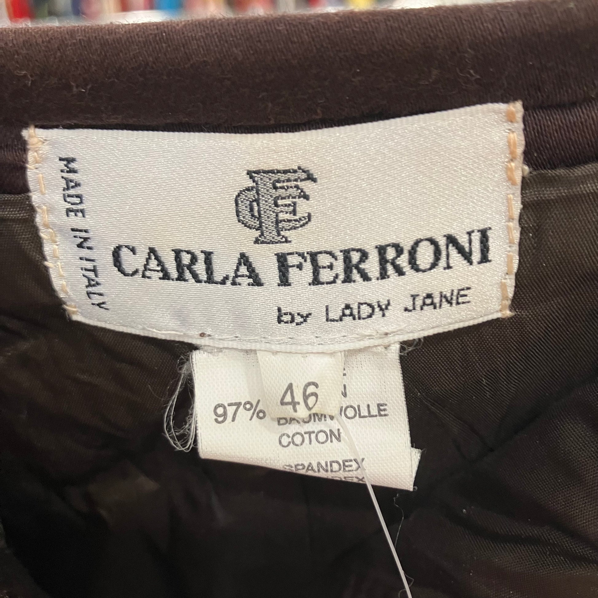Label with 'CARLA FERRONI by LADY JANE' on a dark fabric background