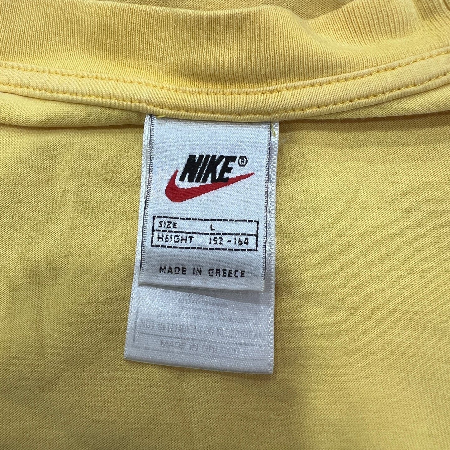 nike 00s yellow tshirt with black swoosh logo
