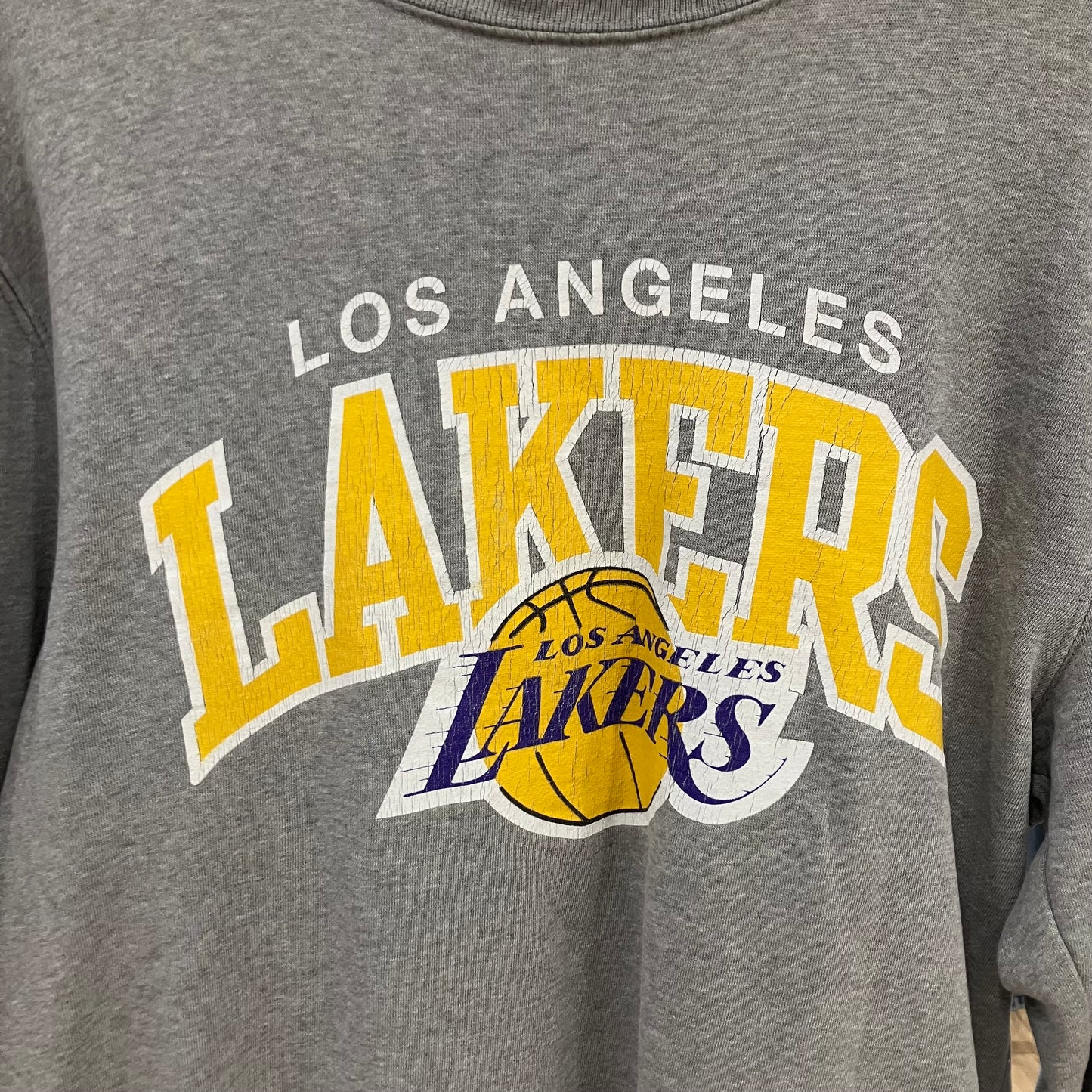 Gray sweatshirt with Los Angeles Lakers logo on a gray background