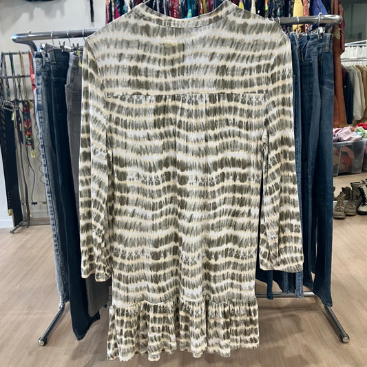 Long-sleeve patterned dress on a rack with jeans in a store setting