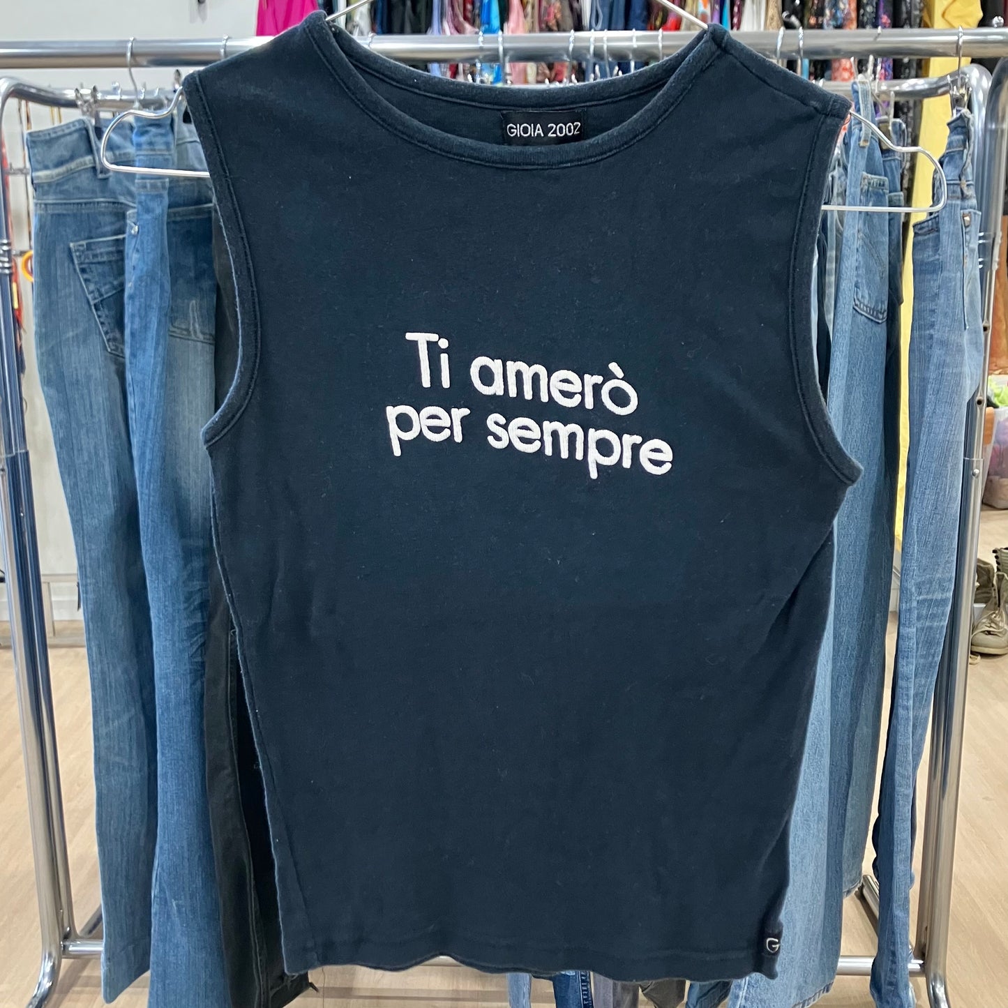 Black tank top with Italian text on a clothing rack