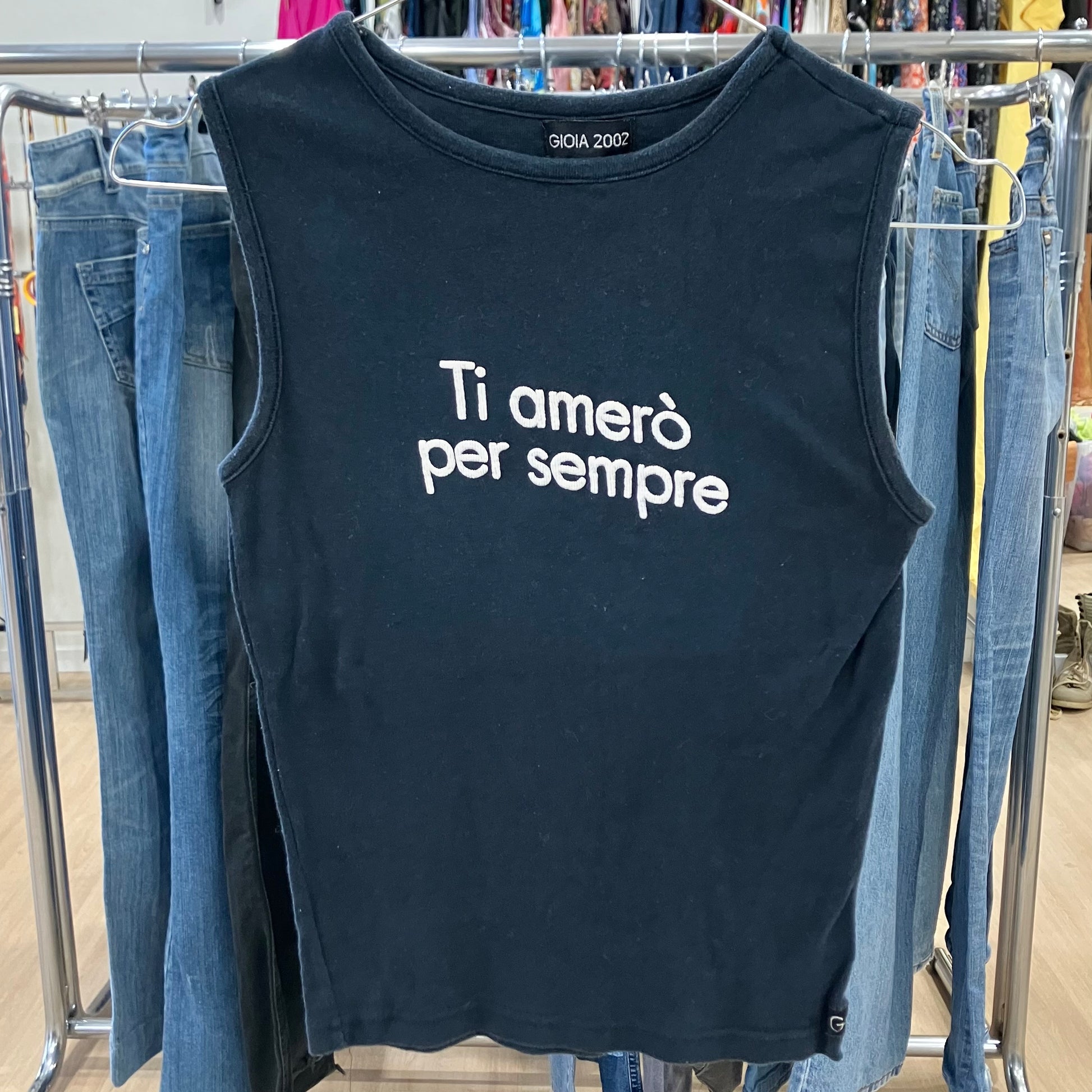 Black tank top with Italian text on a clothing rack