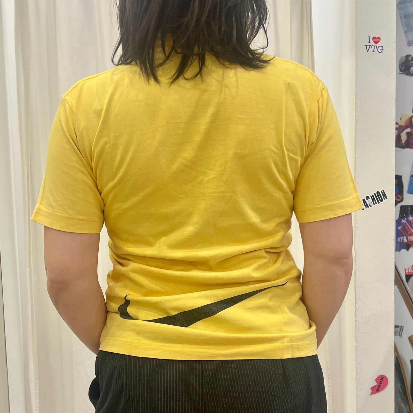 nike 00s yellow tshirt with black swoosh logo