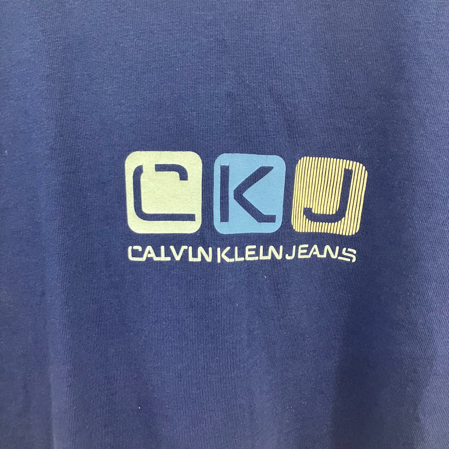 Calvin Klein Jeans logo on a blue background