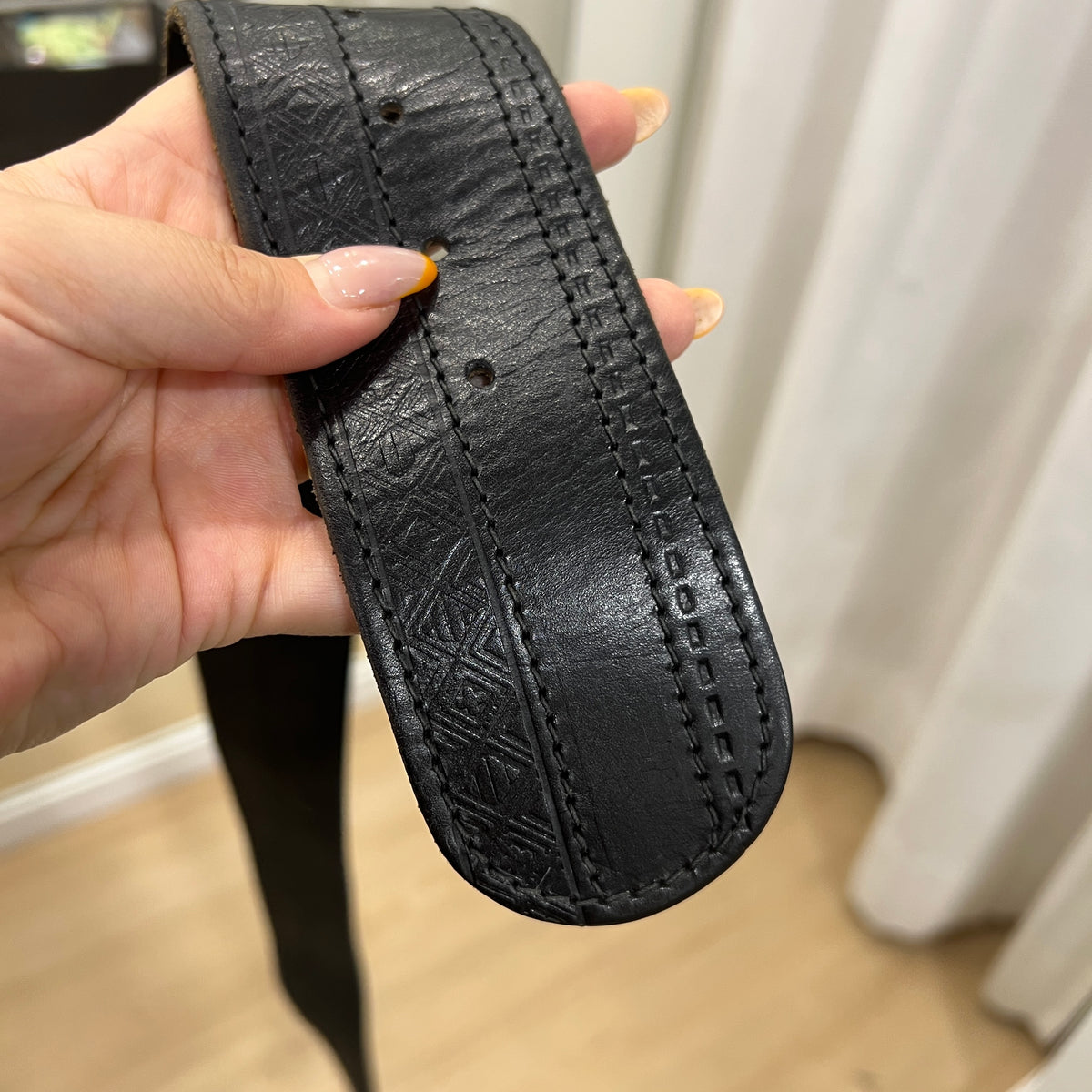 black leather belt embossed with geometric print