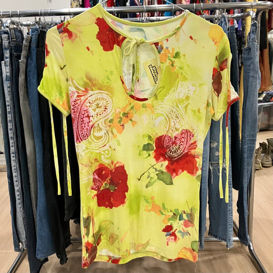 Floral dress with red flowers on a rack with jeans