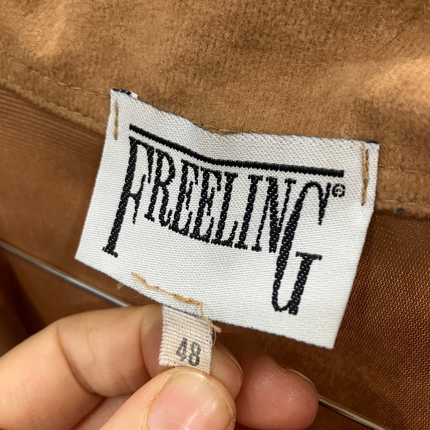 Close-up of a Freeling label on a brown fabric background