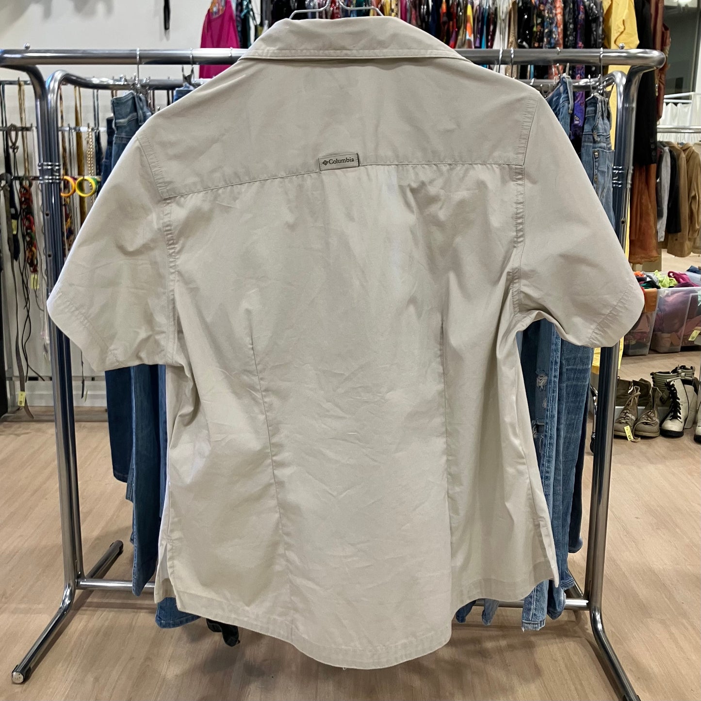 Beige shirt on a rack in a store setting