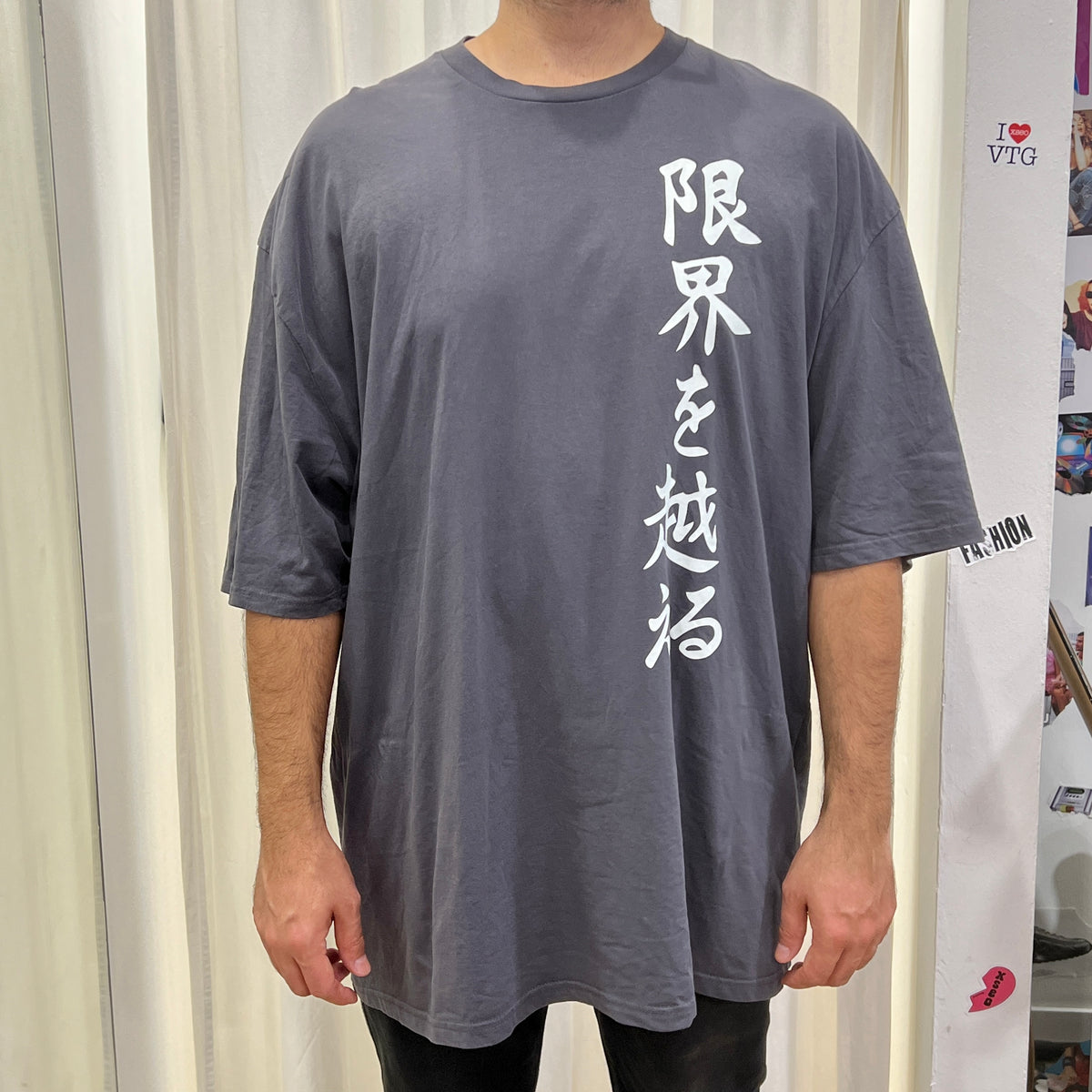 karate event merch grey tshirt with white japanese writing: go beyond your limits
