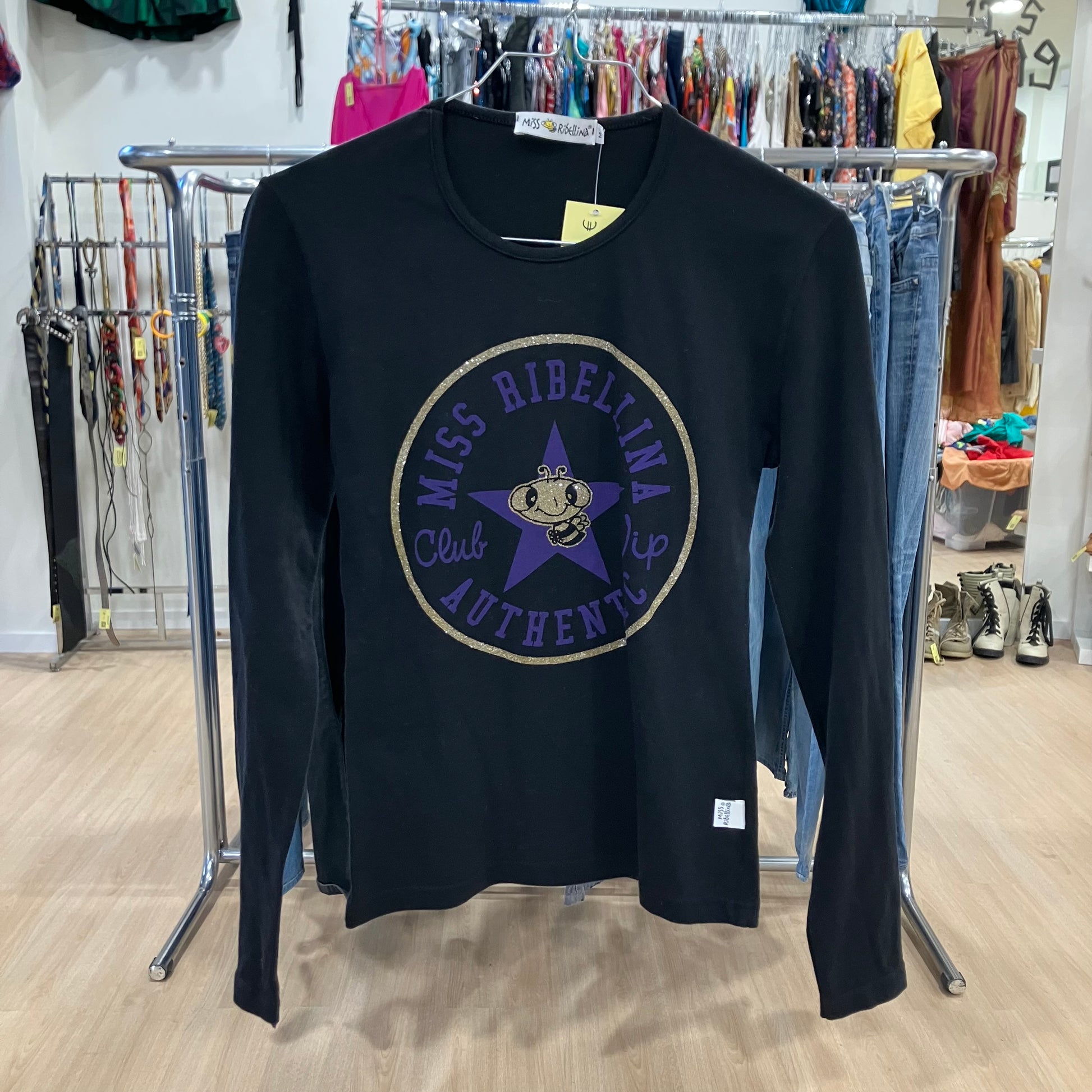 Black long-sleeve shirt with a logo in a clothing store