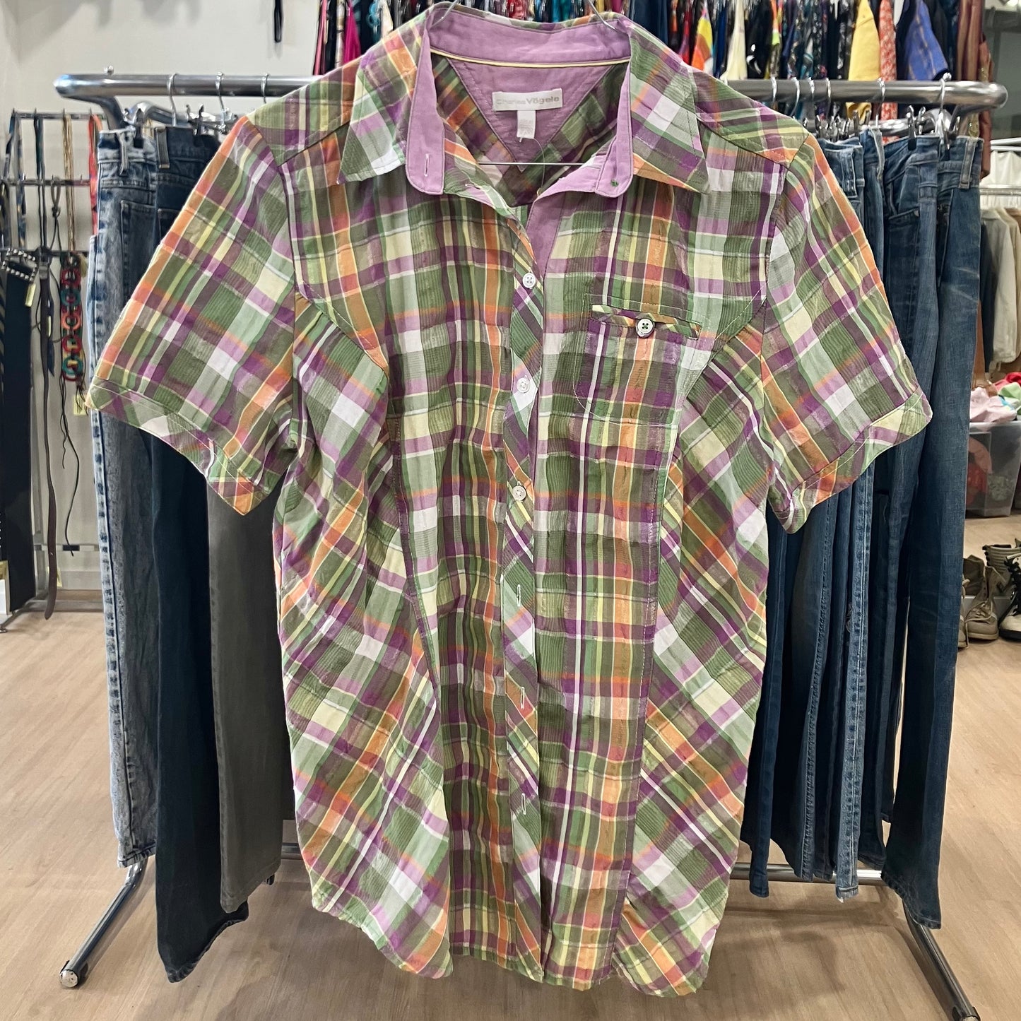 Plaid shirt on a rack with jeans in a store setting