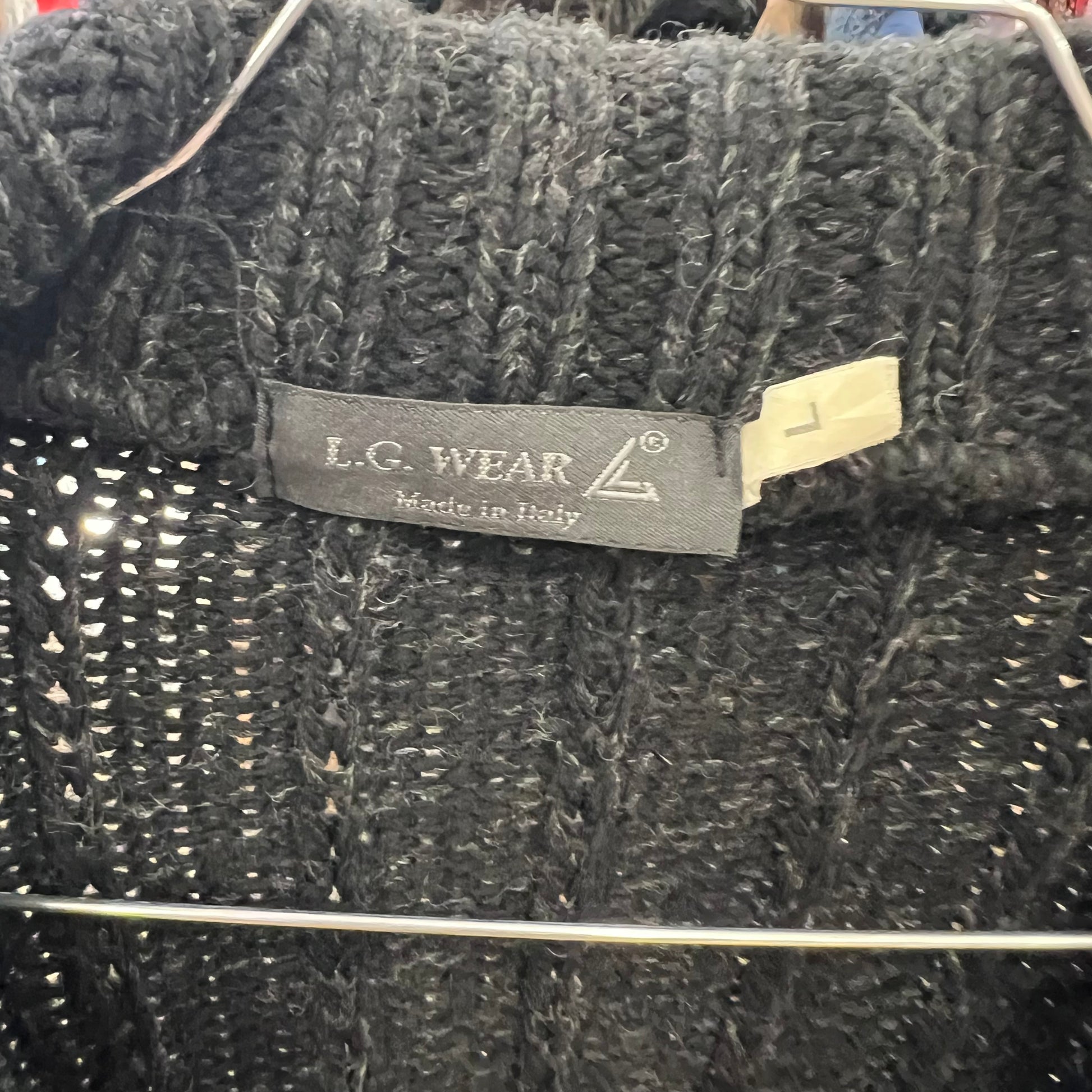 Dark textured fabric with L.C. Wear label on a hanger