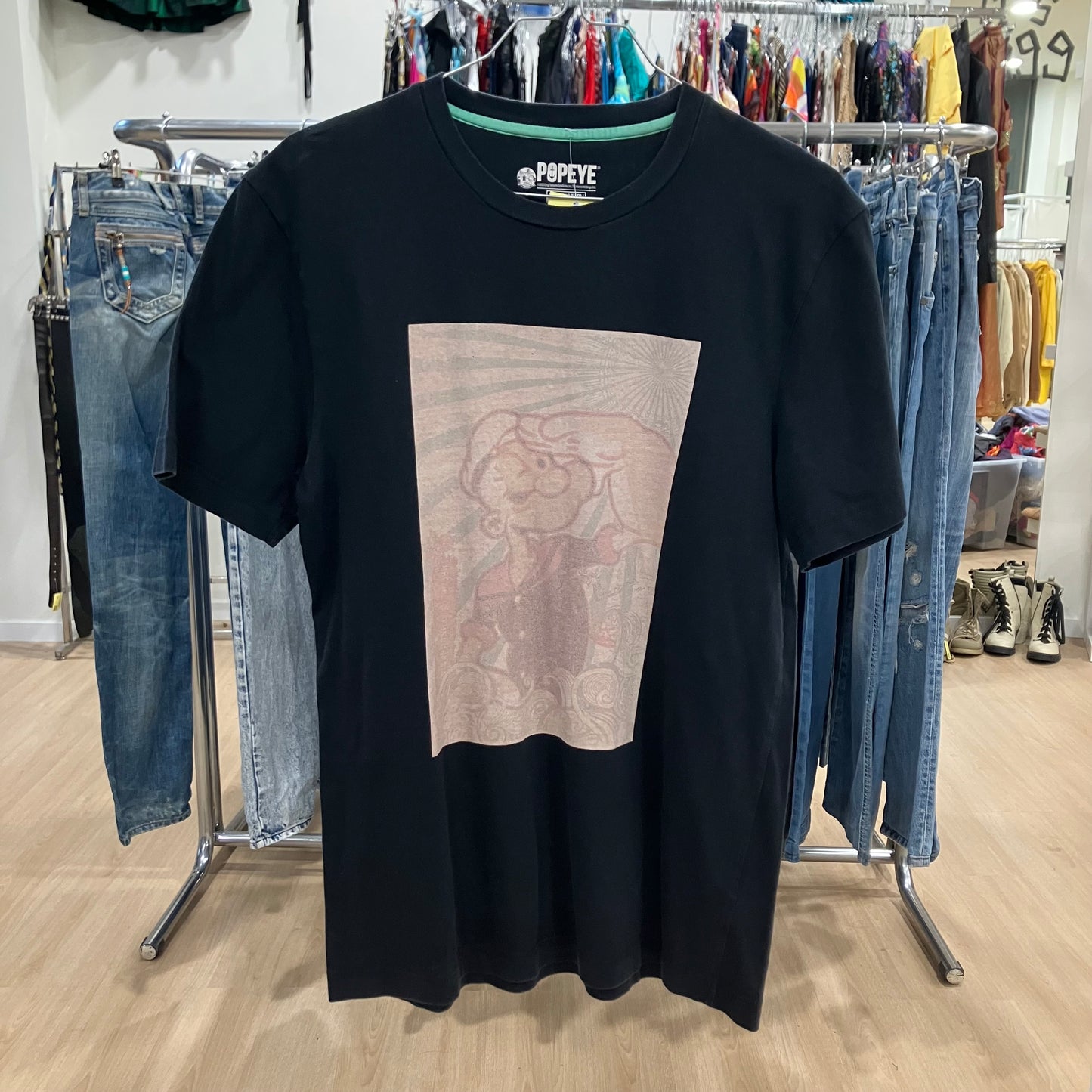 Black t-shirt with graphic design in a clothing store