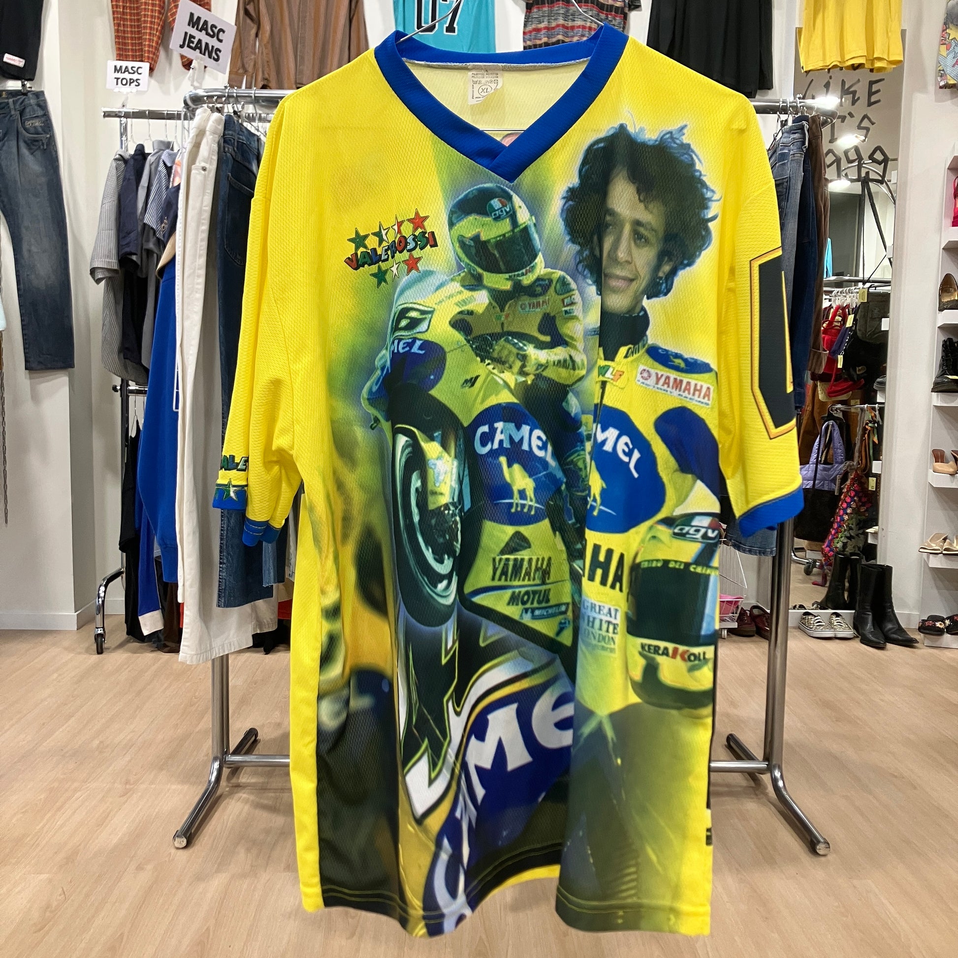 Yellow sports jersey with graphics and text in a store setting