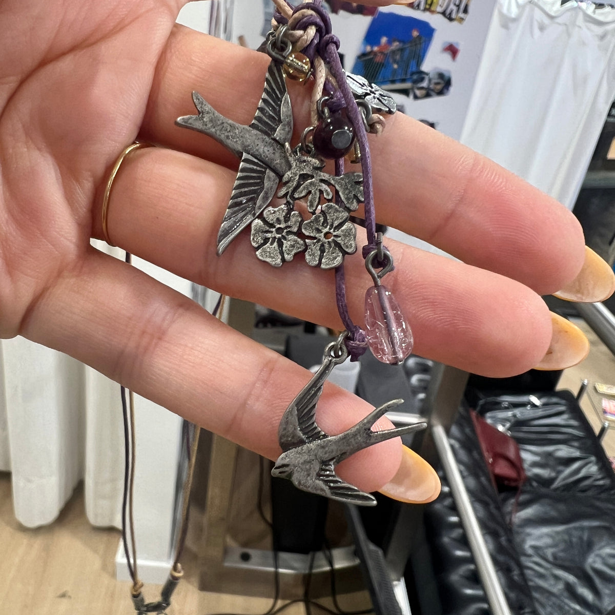 boho whimsy string necklace with silver floral and swallow pendants