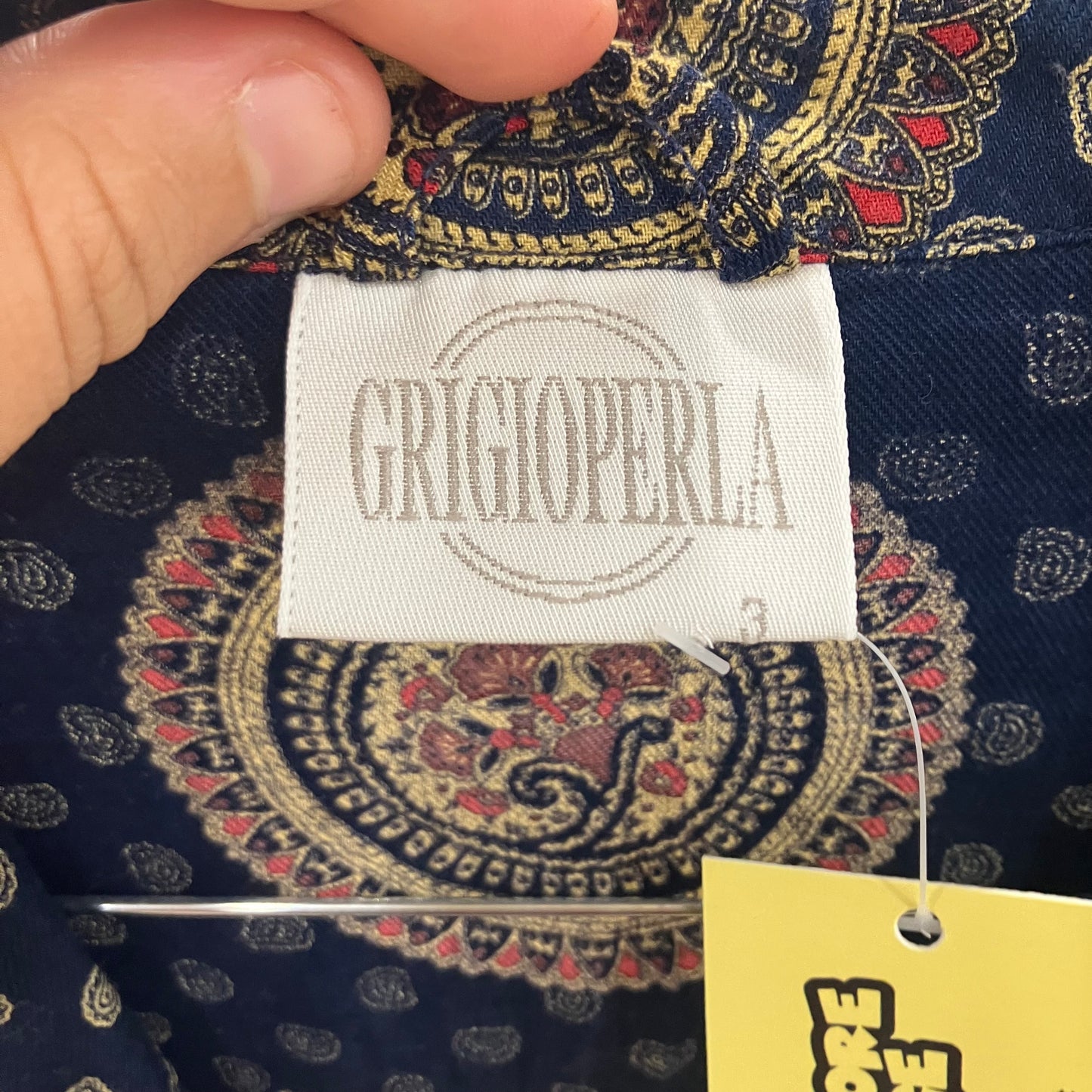 Close-up of a patterned fabric with a Grigio Perla label