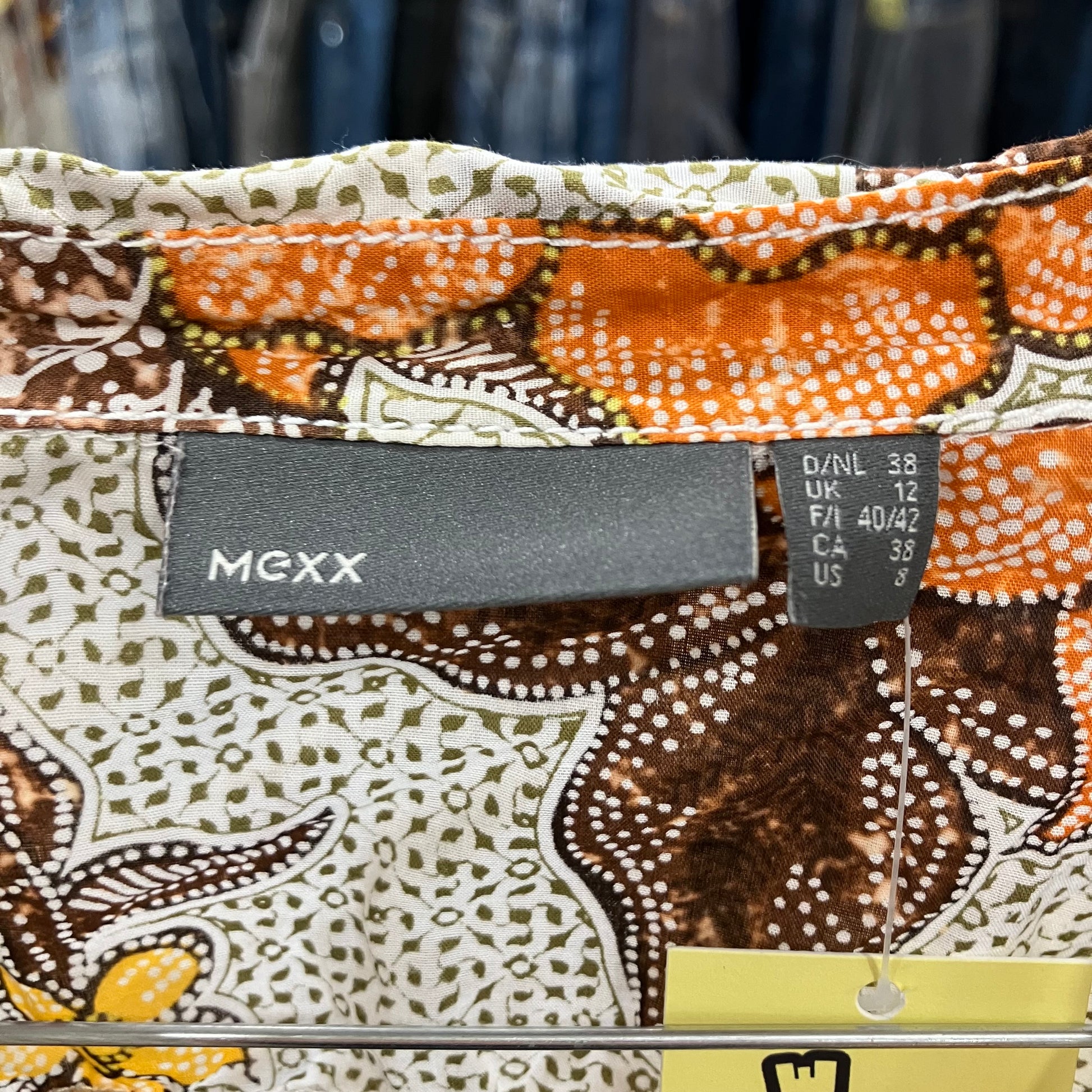 Patterned fabric with a MEXX label on a clothing rack