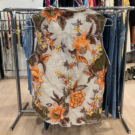 Floral embroidered dress on a rack with jeans in the background