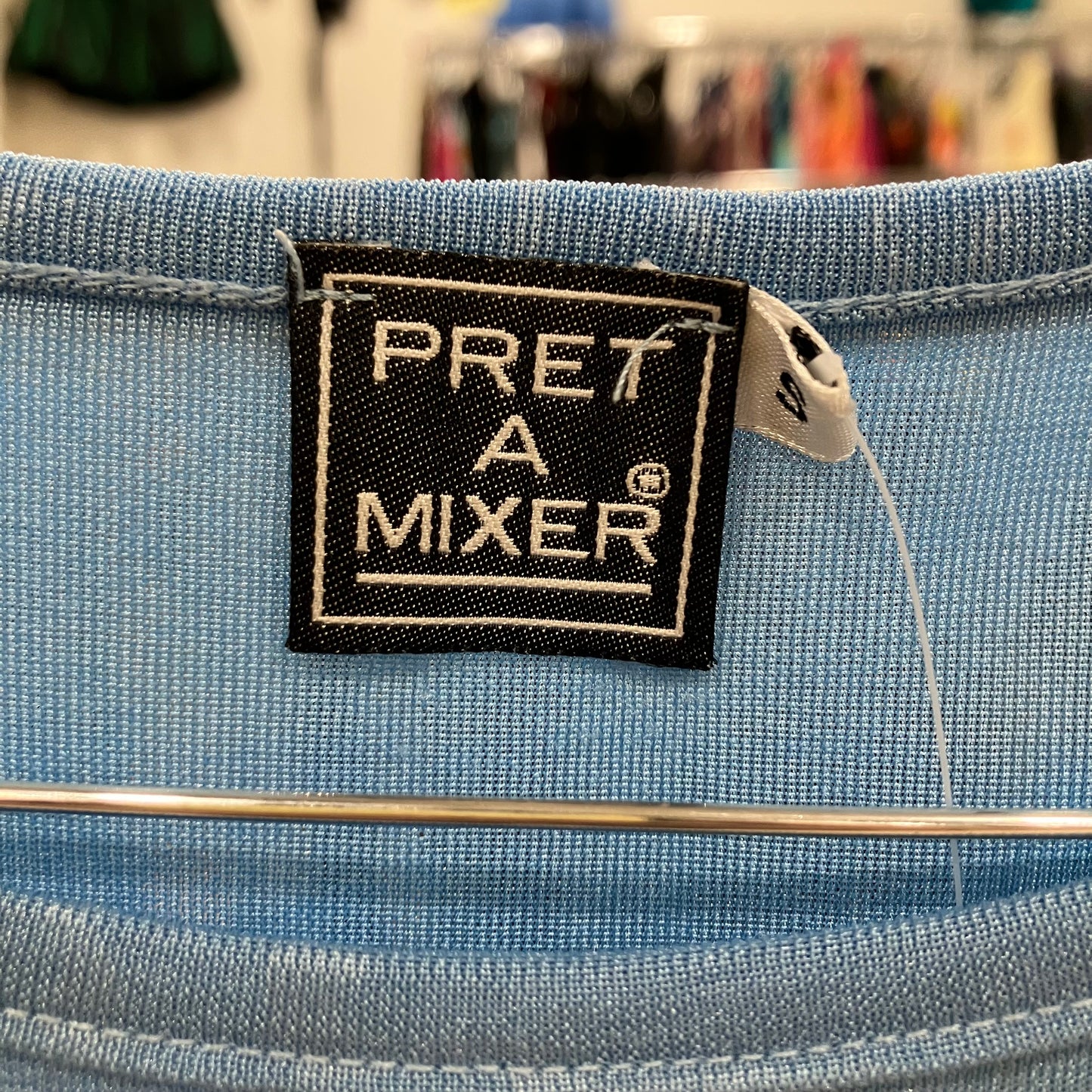 Label on a blue fabric item with 'PRET A MIXER' branding