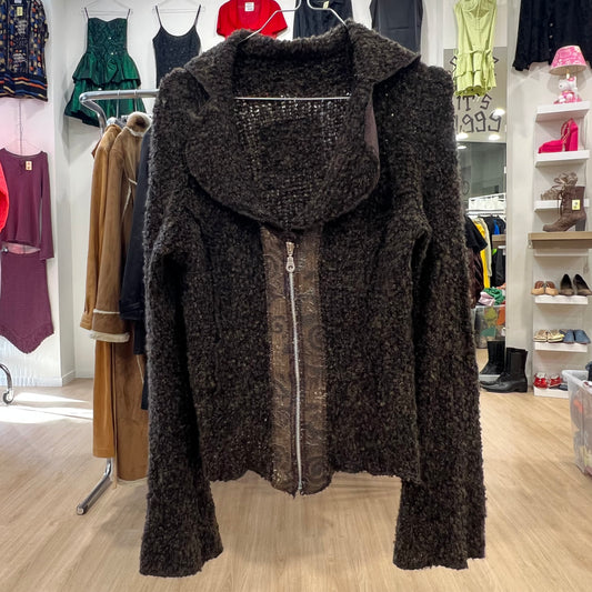 Brown textured jacket with a zipper in a clothing store setting