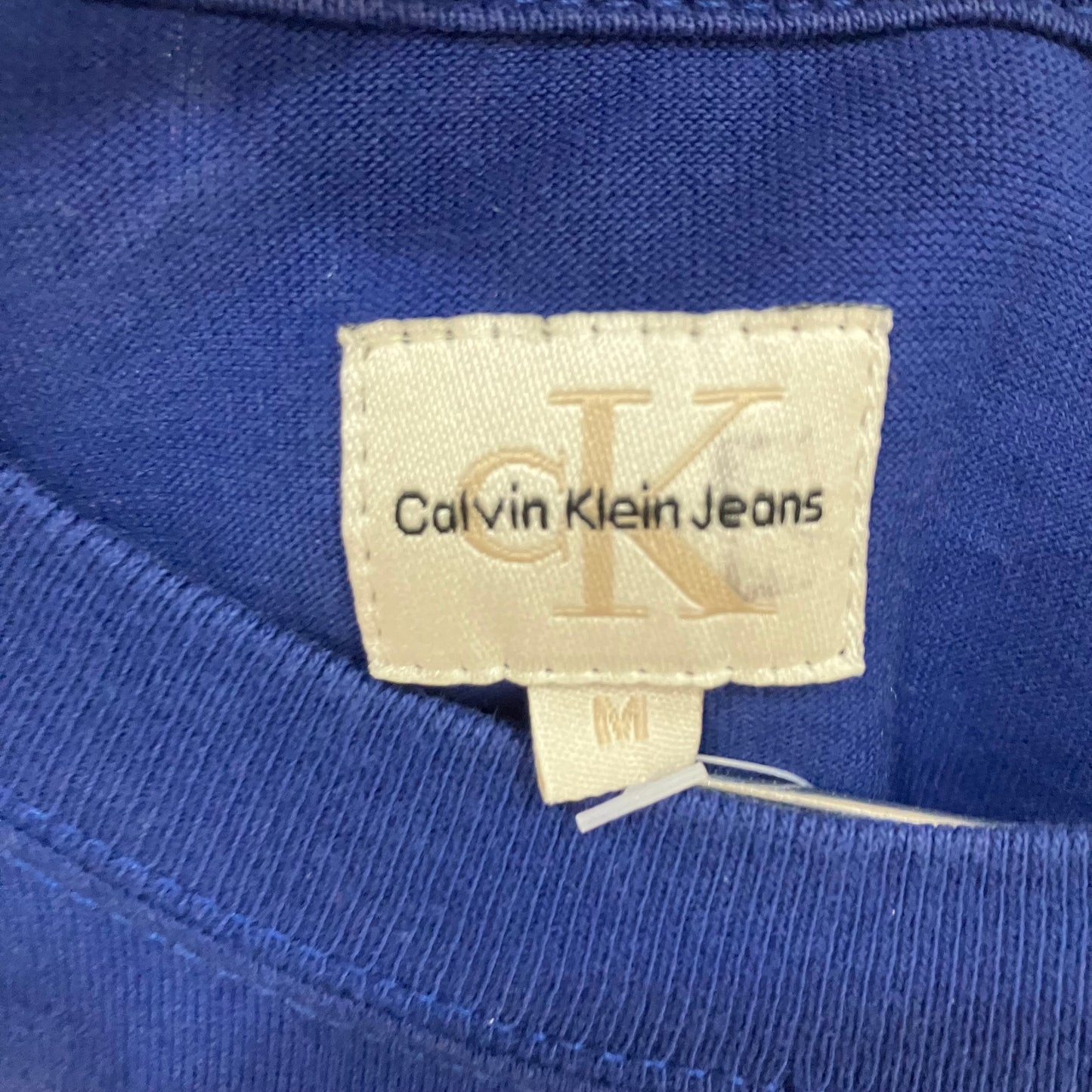 Calvin Klein Jeans label on a blue garment