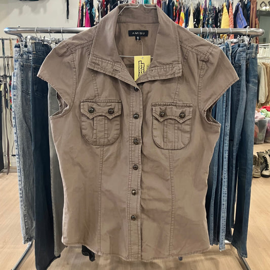 Beige sleeveless shirt with a brand tag on a rack in a store setting