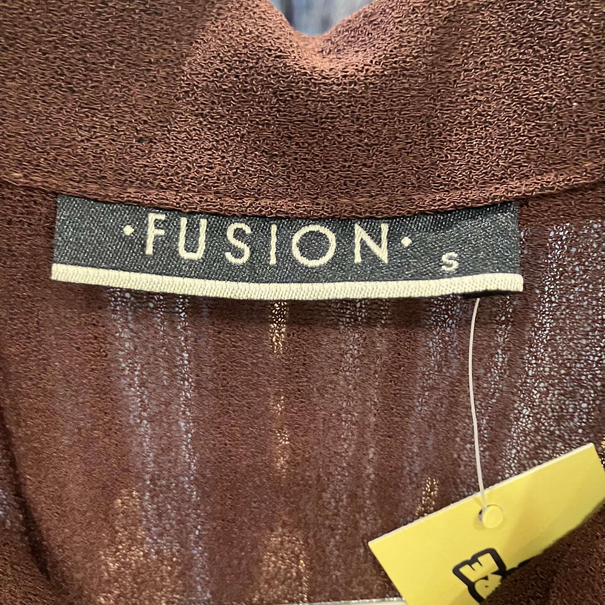 Brown garment with 'Fusion' label and size tag on a dark background