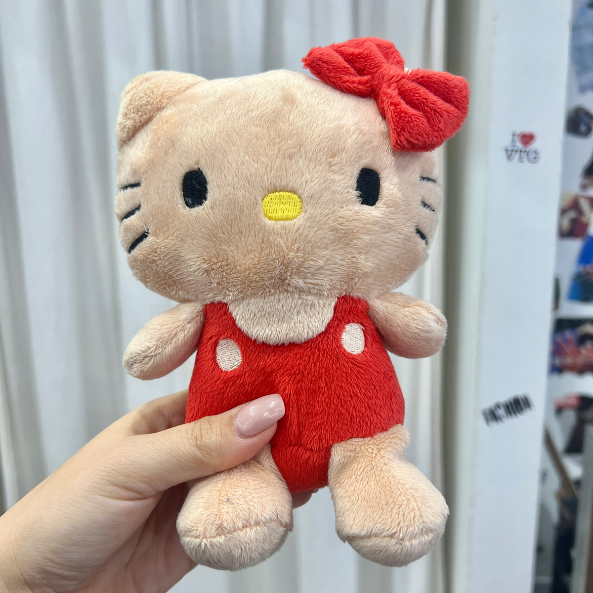 tan hello kitty plushie with red clothes