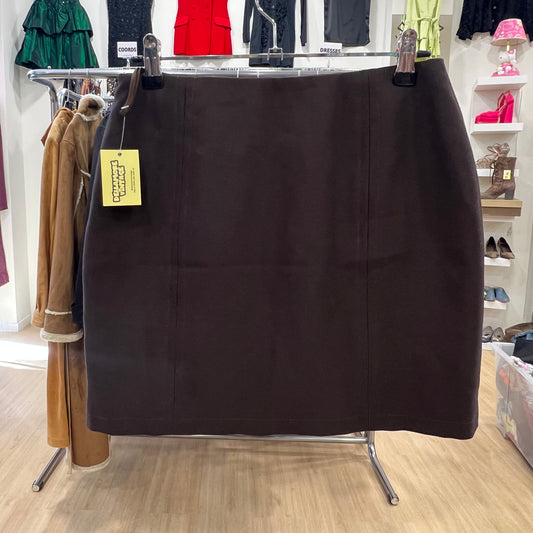 Black skirt on a rack in a store with various clothing items in the background