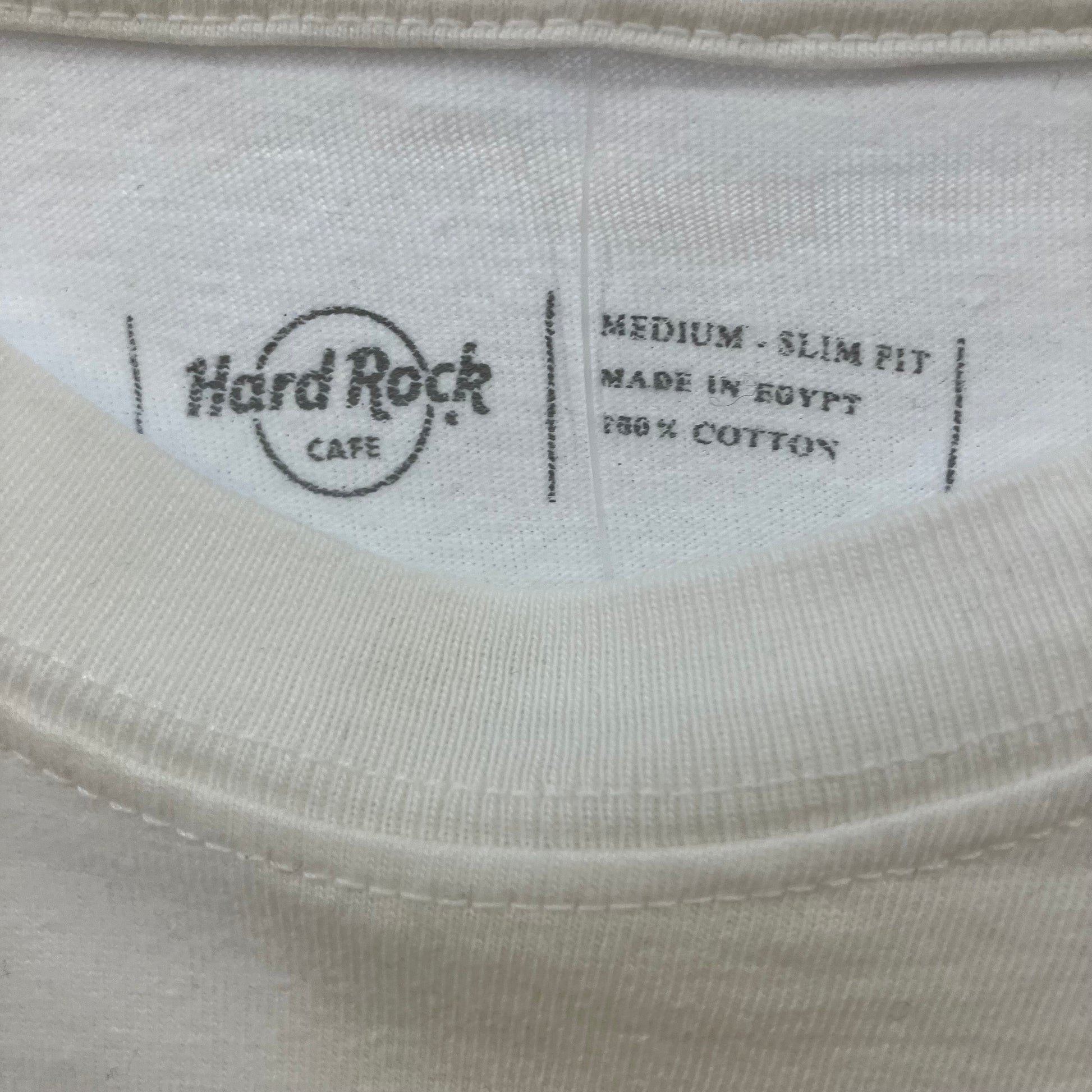 Label on a beige shirt with 'Hard Rock Cafe' branding