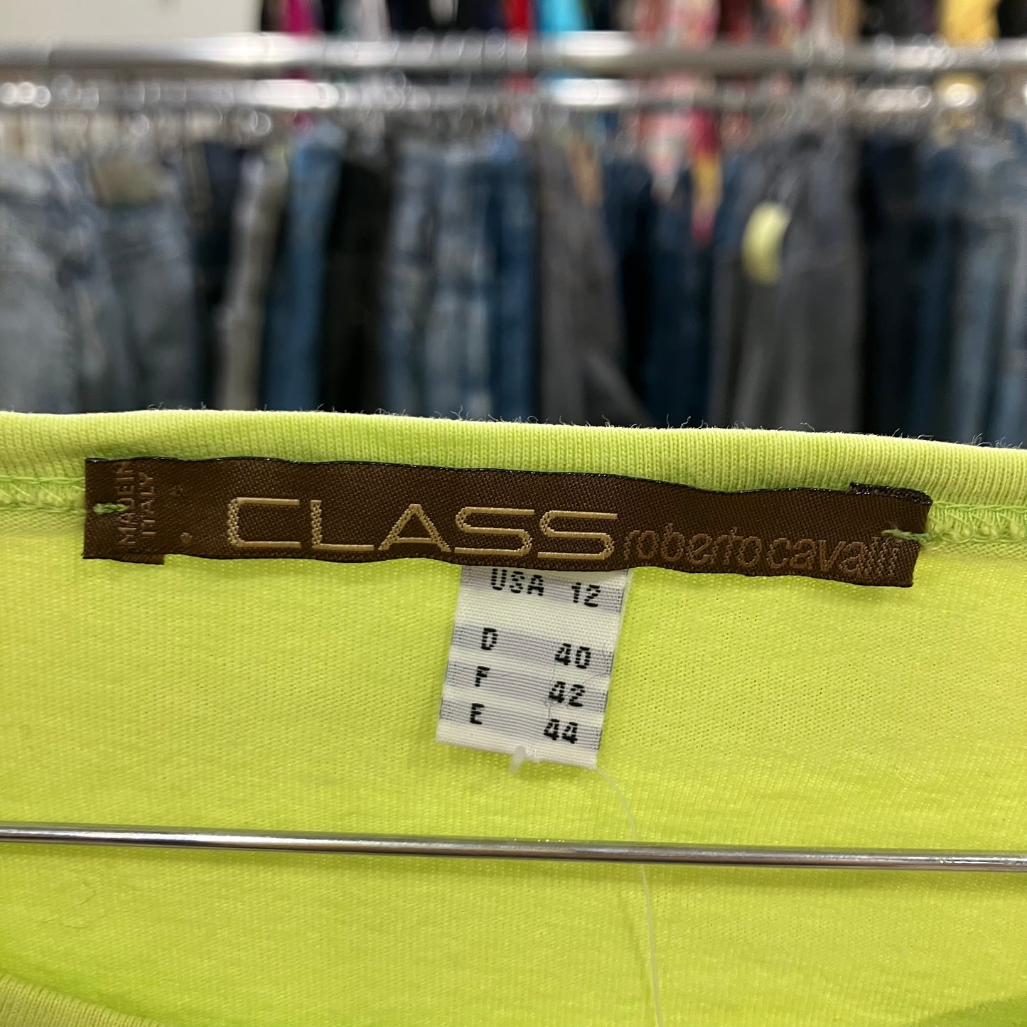 Green fabric with a label on a clothing rack in a store