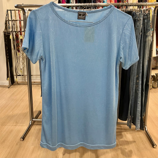 Light blue t-shirt on a hanger with a clothing rack in the background