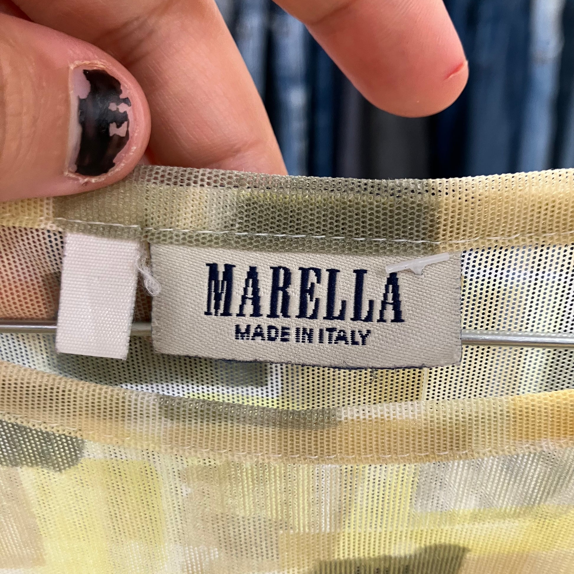 Marella label on a garment with a hand holding it