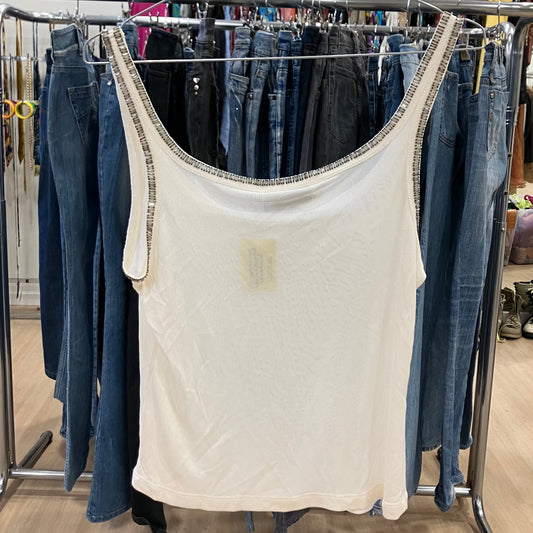 White tank top on a rack with jeans in a store setting