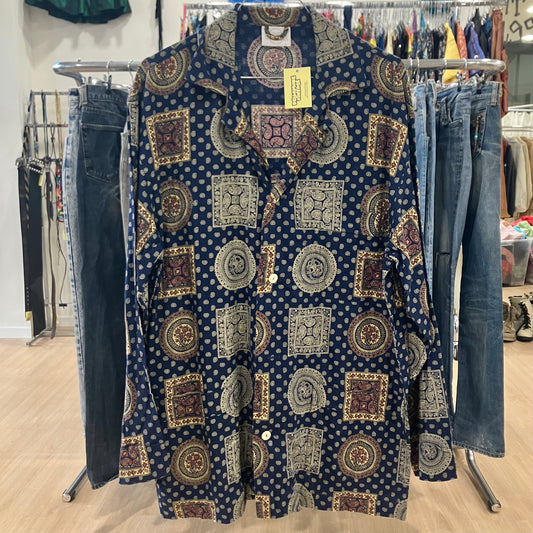 Patterned shirt on a rack with jeans in a store setting