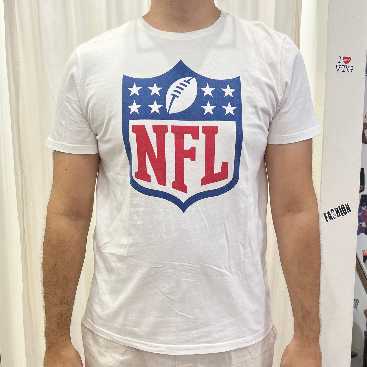 NFL white tee with blue red shield logo