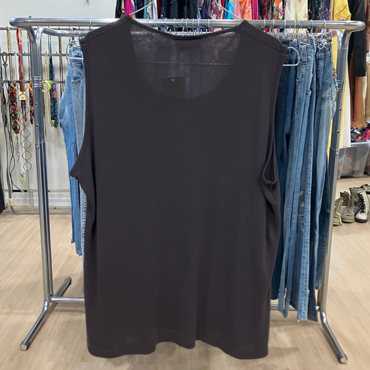 Black sleeveless tank top hanging on a rack inside a clothing store