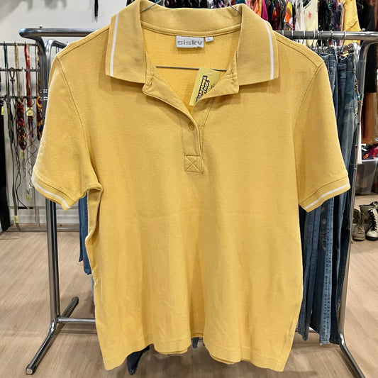 Yellow polo shirt with a tag on a rack in a store setting