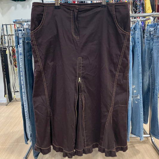 Brown skirt hanging on a rack with jeans in the background