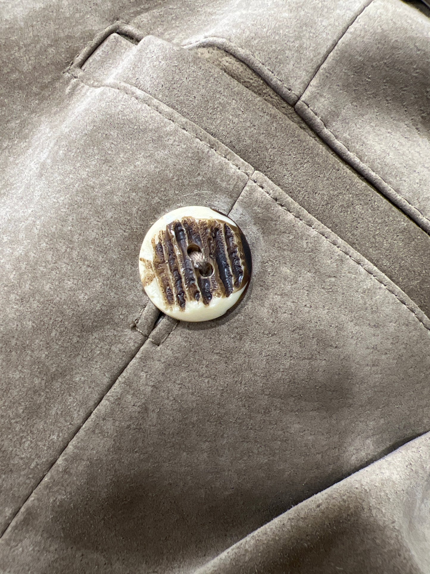 Close-up of a textured fabric surface with a button