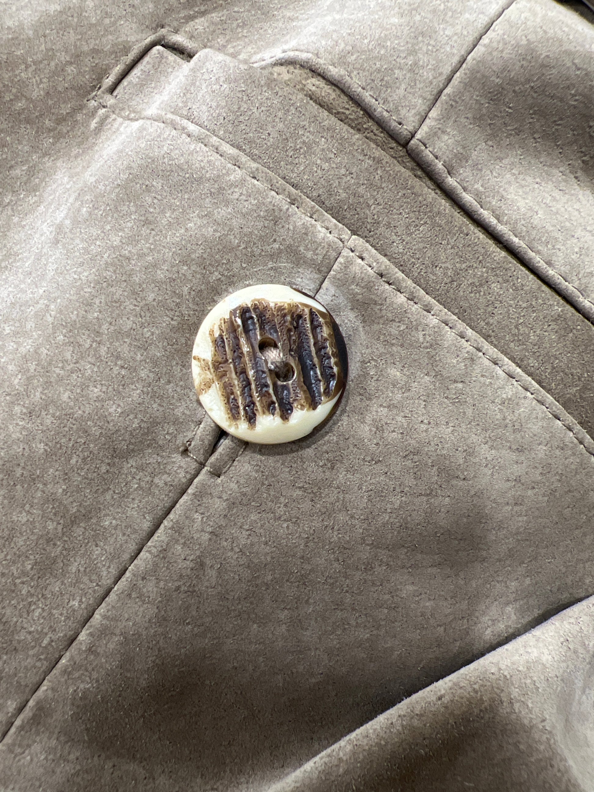 Close-up of a textured fabric surface with a button