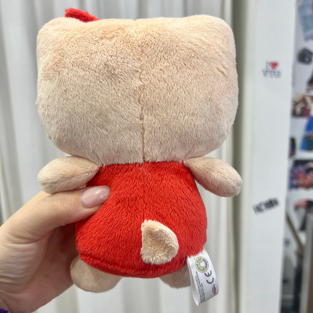 tan hello kitty plushie with red clothes