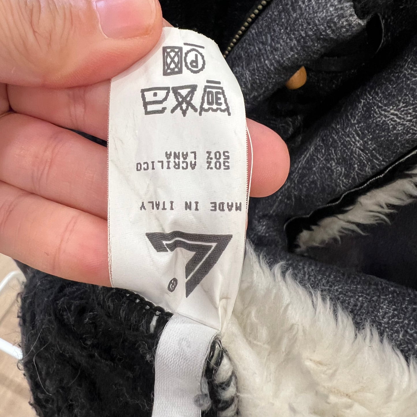 Close-up of a label on a black and white product with text and a logo